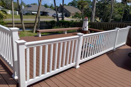 Moisture shield composite deck with white vinyl rail