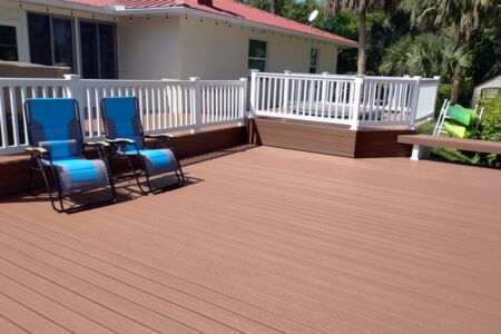 Moisture shield composite deck with white vinyl rail