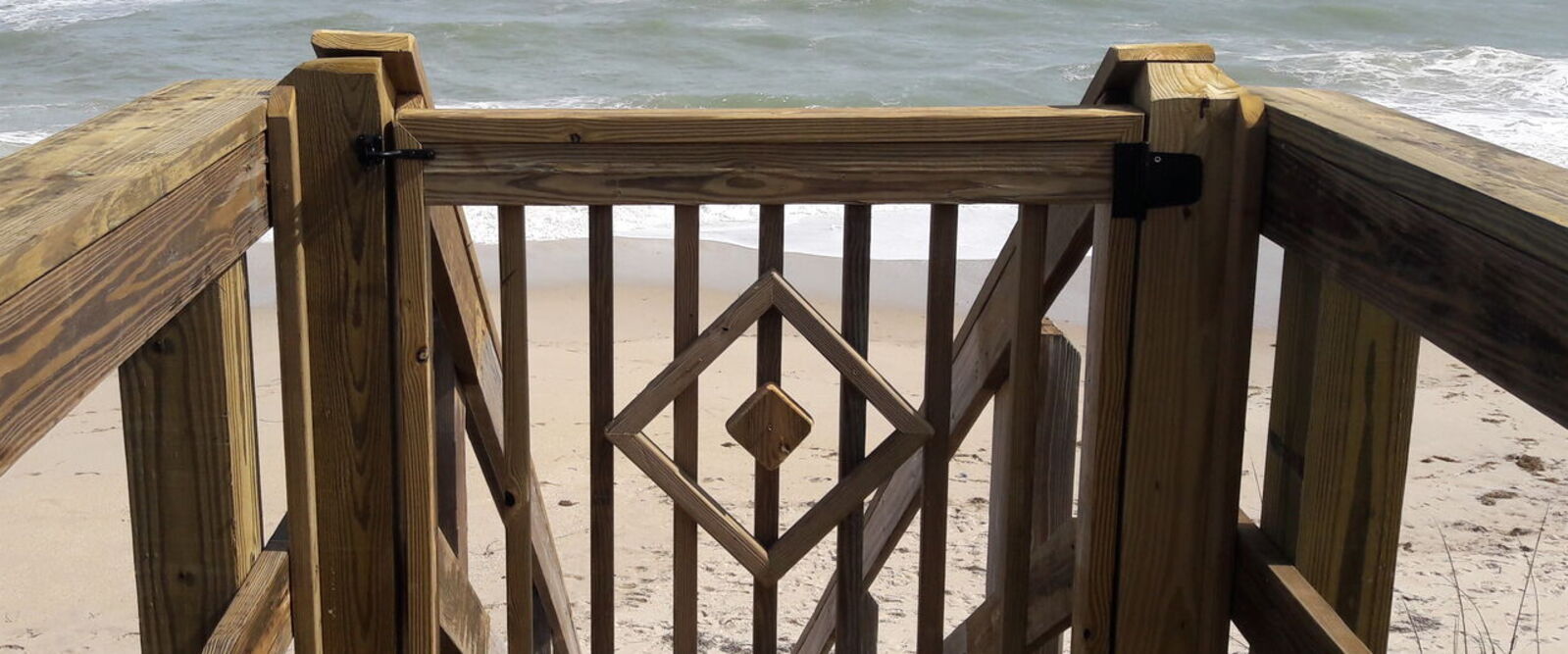 hardwood gate before staircase on a beach access